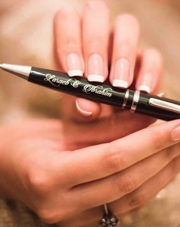 Bride and Groom holding J's Store's Name Engraved Nikkah Pen.