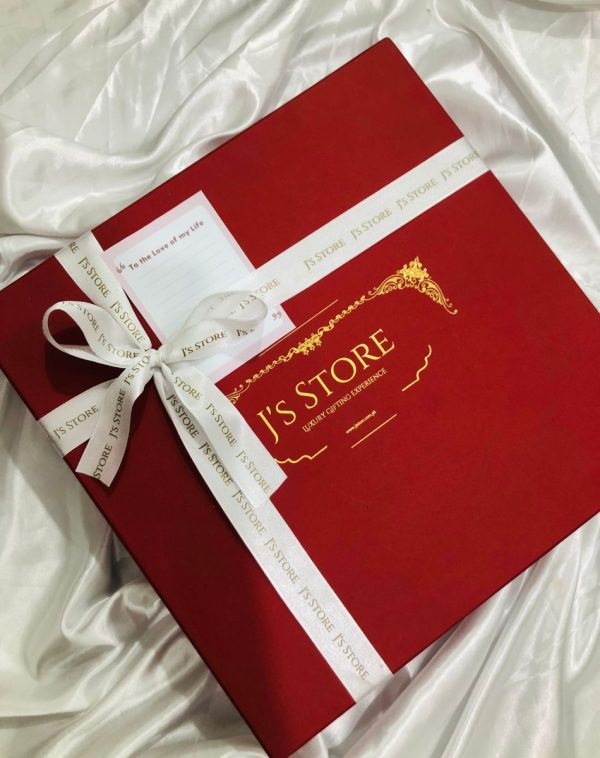 Premium Gift Box in Red Color wrapped and decorated with White elegant ribbons.