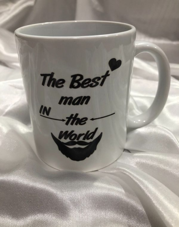 Customized White Mug with 'The Best Man in the World' Black Print on it. White Silk Background in the picture.