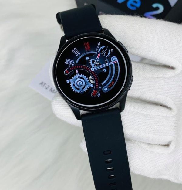 AT-2 Max Smartwatch cradled in a gloved hand, boasting a sleek black strap and a sophisticated black dial.