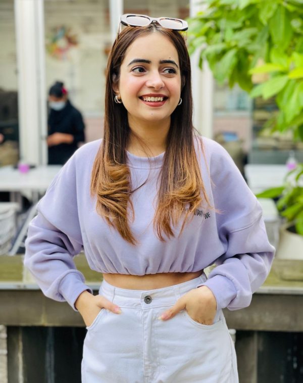 Close-up detail of the Lilac Cropped Drop Shoulder Scannable Sweatshirt worn by Palvi Ramani, highlighting the fleece material and intricate design.