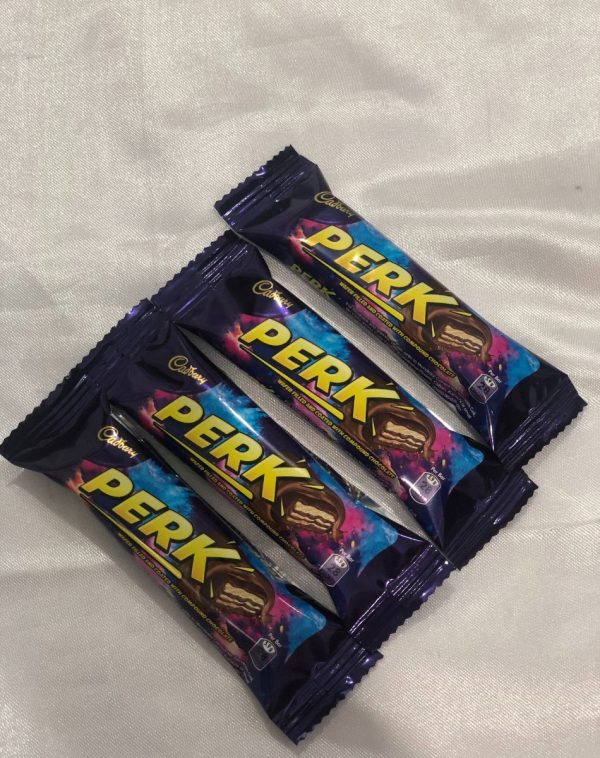 Four Perk chocolate bars nestled on a crisp white sheet, decadent treats, smooth indulgence, perfect snack, J's Store.