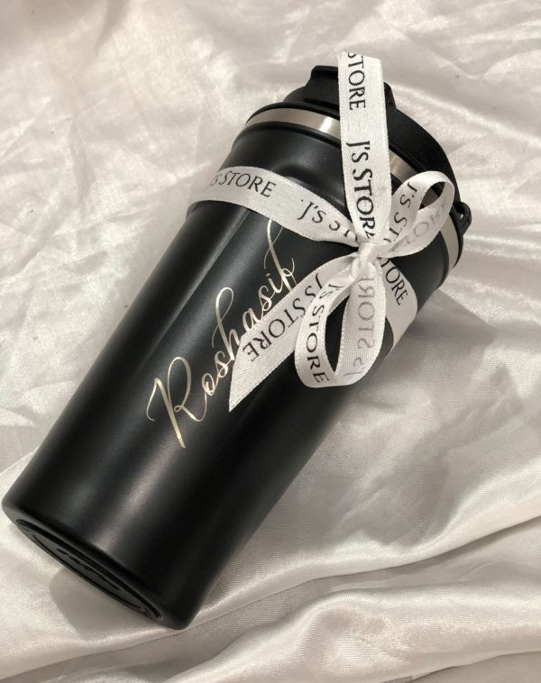 Black coffee tumbler with customized name engraving.