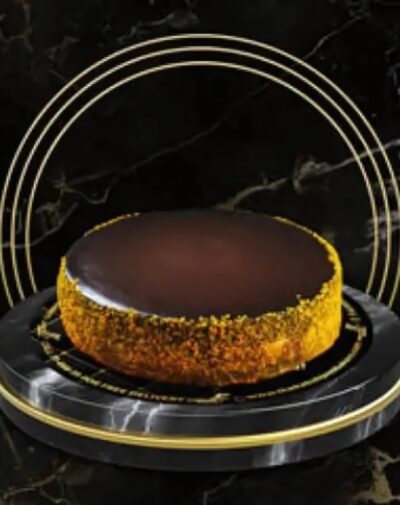 Alt Text: Three Milk Cake by J’s Store with chocolate glaze and caramel nut crust, available for online delivery in Karachi.