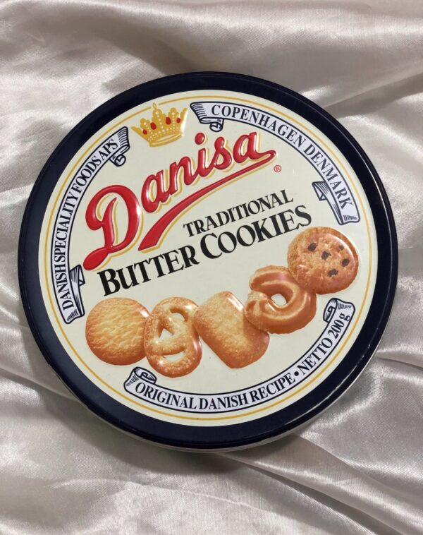 A metal tin of Danisa Traditional Butter Cookies, 200g. The lid has a Danish design with pictures of various cookies.