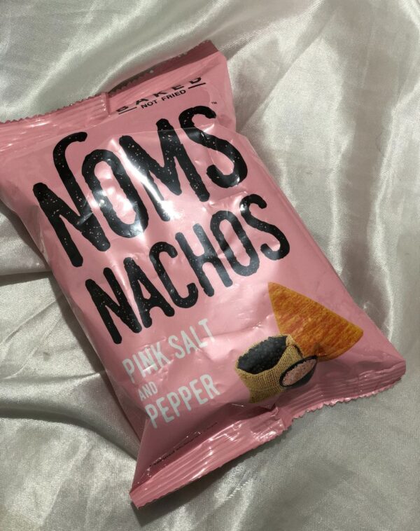 A bag of "Noms Nachos" with "Pink Salt and Pepper" flavor.