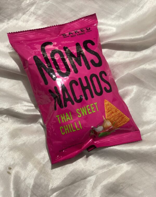 A pink bag of Noms Nachos in the Thai Sweet & Chilli flavor.