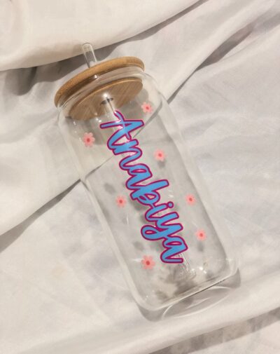 Customized Name Glass Tumbler with bamboo lid and straw, featuring the floral design and the custom name "Anabiya" in pink and blue vinyl.