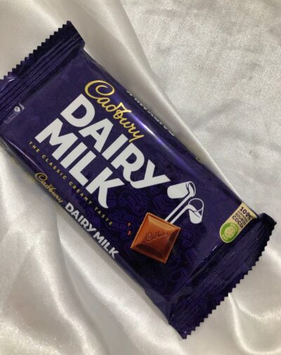 Dairy Milk chocolate bar in its classic purple wrapper, showing the creamy texture.