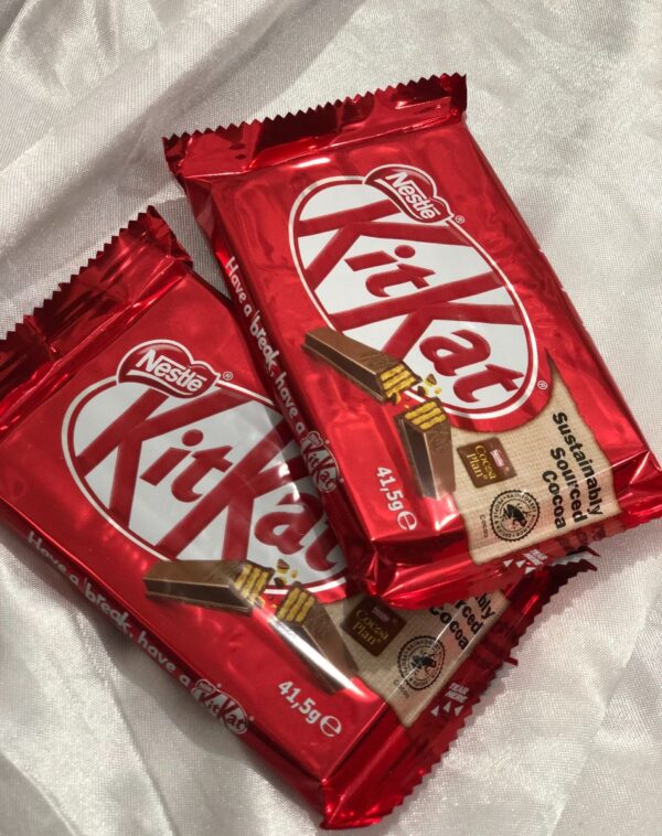 Two red wrappers of KitKat 4F 41.5g chocolate bars showing the four-finger break.