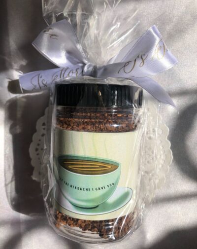 Mini Coffee Jar from J’s Store with coffee granules and a witty label, tied with a white ribbon.