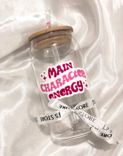 Trendy Decal Glass Tumbler (Customizable) with bamboo lid, straw, and "Main Character Energy" decal in pink, black, and white.