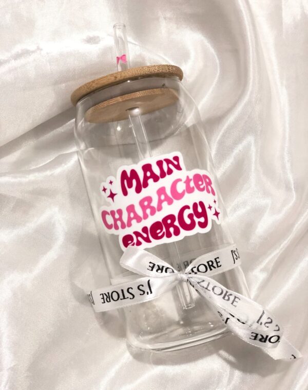 Trendy Decal Glass Tumbler (Customizable) with bamboo lid, straw, and "Main Character Energy" decal in pink, black, and white.
