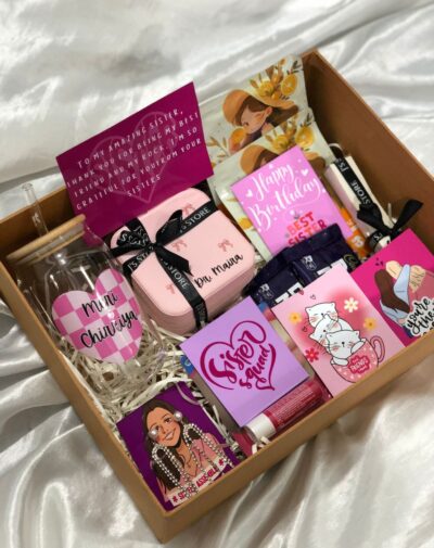 Vibe Check Gift Box is a pink and white gift box showing a Customized Name Glass Tumbler, Customized Jewelry Organizer, and various beauty items.