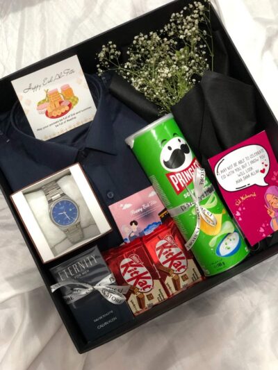 The Better Than Eidi Box featuring two stitched suits and CK Eternity perfume for men.